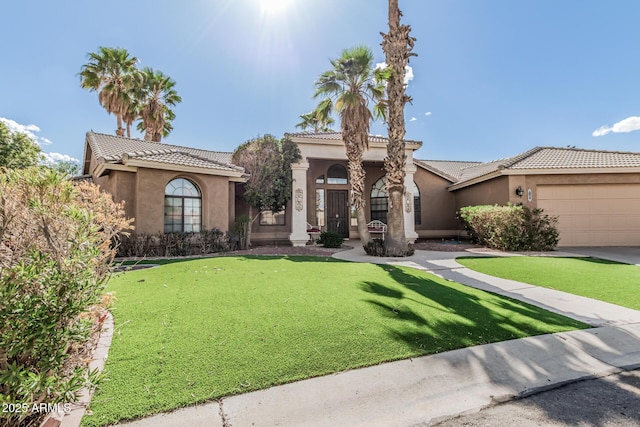 1207 E Clearview Dr, Casa Grande, AZ 85122 - mediterranean / spanish-style house featuring a garage, a tile roof, a front yard, and stucco siding
