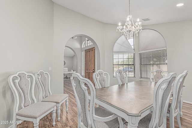 1207 E Clearview Dr, Casa Grande, AZ 85122 - dining room featuring visible vents, arched walkways, wood finished floors, a chandelier, and recessed lighting