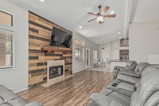 1207 E Clearview Dr, Casa Grande, AZ 85122 - living room featuring a healthy amount of sunlight, ceiling fan, a fireplace, and wood finished floors