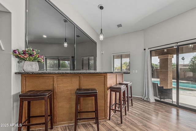 1207 E Clearview Dr, Casa Grande, AZ 85122 - bar with pendant lighting, bar, wood finished floors, and visible vents
