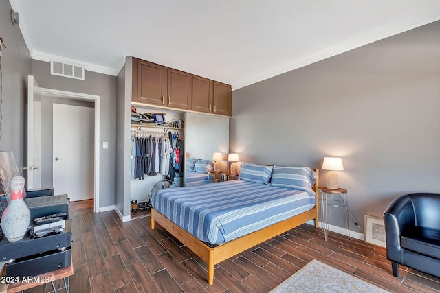 bedroom with crown molding and a closet