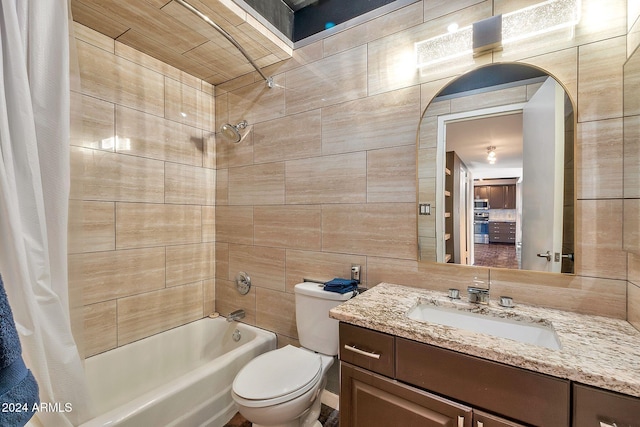 full bathroom with shower / bath combo, vanity, toilet, and tile walls