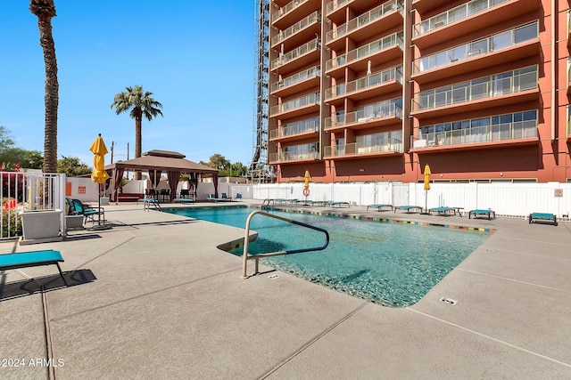 view of swimming pool with a gazebo and a patio