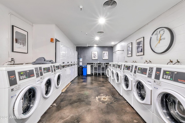 clothes washing area featuring stacked washer / drying machine and washing machine and clothes dryer