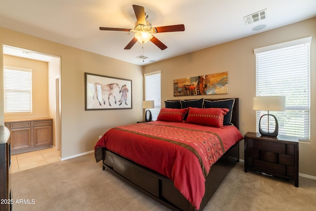 bedroom featuring visible vents, light carpet, and baseboards