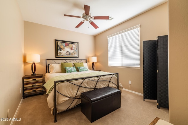 carpeted bedroom featuring visible vents, baseboards, and ceiling fan