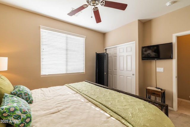 bedroom featuring a closet, carpet flooring, baseboards, and a ceiling fan