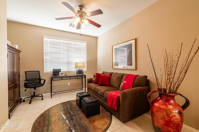 living room featuring light tile patterned floors, visible vents, baseboards, and a ceiling fan