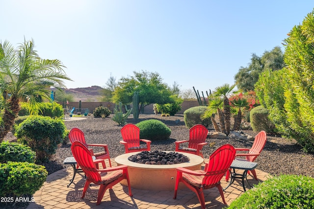 view of patio / terrace with fence and an outdoor fire pit