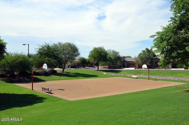 view of property's community with community basketball court and a lawn