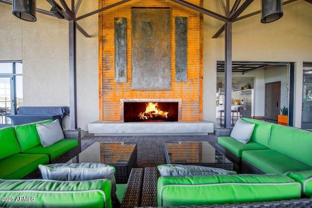 view of patio with an outdoor living space with a fireplace