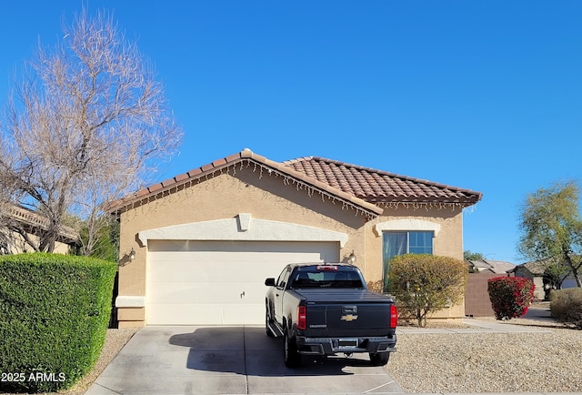 mediterranean / spanish-style house with a tile roof, stucco siding, concrete driveway, and a garage