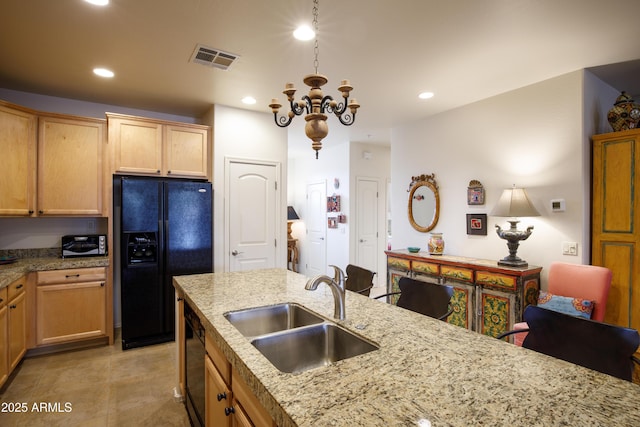 kitchen featuring black appliances, recessed lighting, visible vents, and a sink