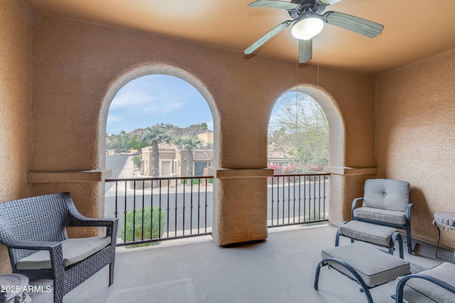 view of patio / terrace featuring ceiling fan and a balcony