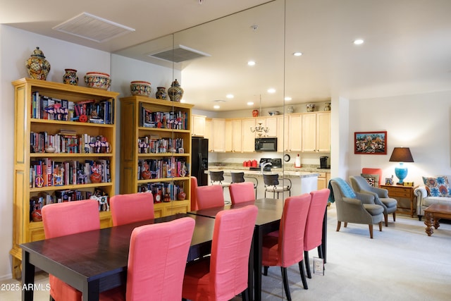 dining space featuring light carpet, visible vents, and recessed lighting