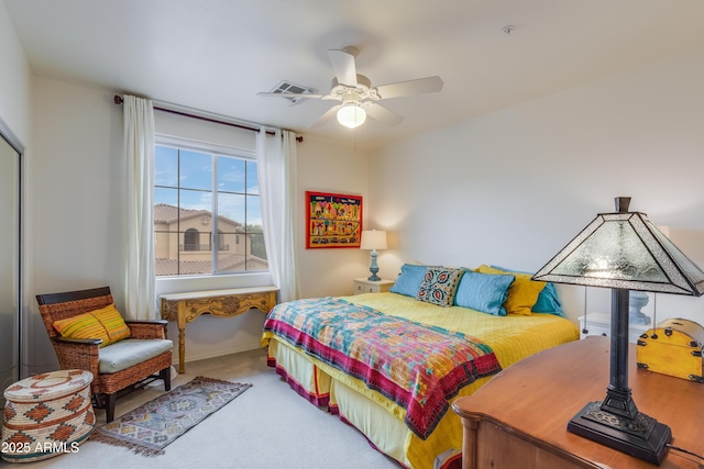 carpeted bedroom with visible vents and a ceiling fan