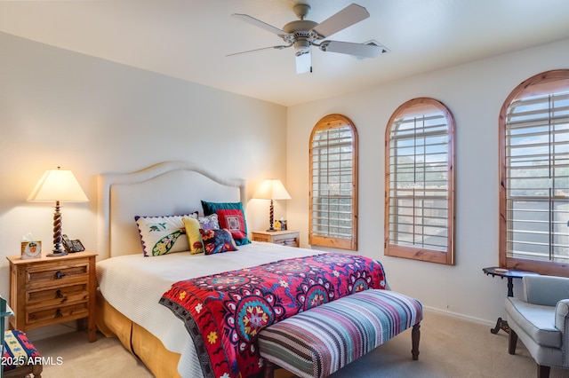 carpeted bedroom with baseboards and a ceiling fan