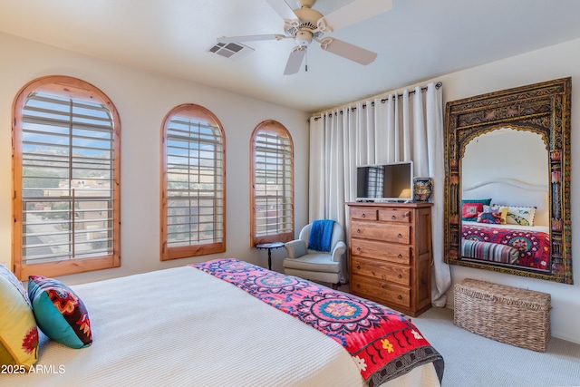 bedroom with carpet flooring, multiple windows, a ceiling fan, and visible vents