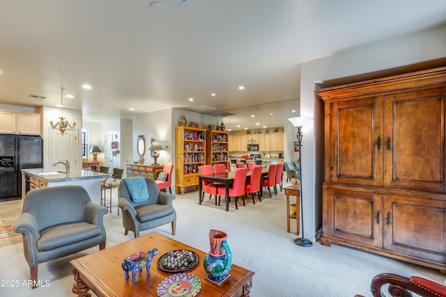 living area with visible vents, recessed lighting, and light colored carpet