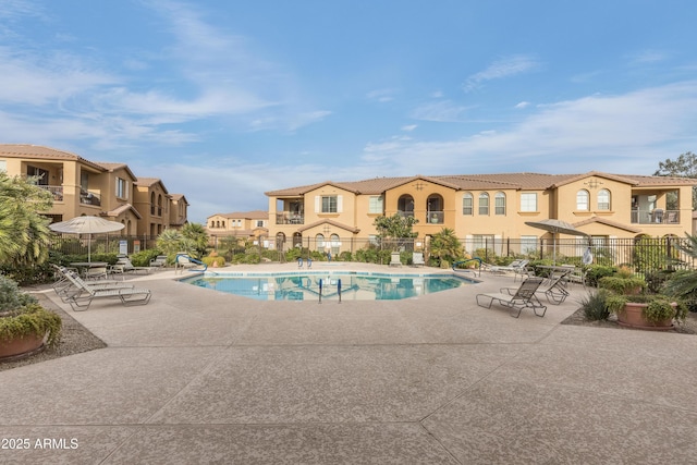 pool featuring a patio area, a residential view, and fence