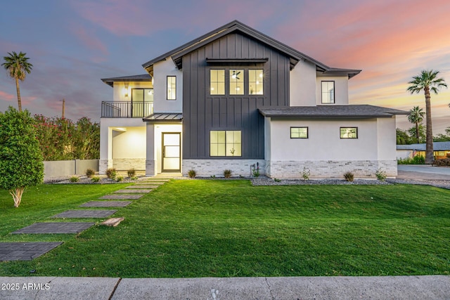 4813 E Earll Dr, Phoenix, AZ 85018 - rear view of property featuring a balcony, board and batten siding, a lawn, and a standing seam roof