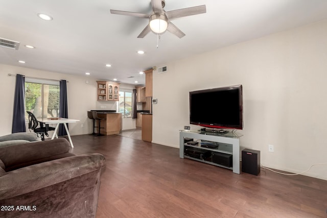 living area with ceiling fan, visible vents, wood finished floors, and recessed lighting