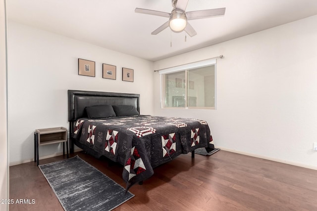 bedroom with a ceiling fan, baseboards, and wood finished floors