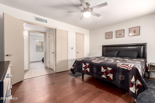 bedroom featuring visible vents, ceiling fan, and wood finished floors