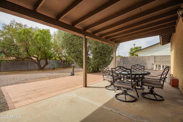 view of patio featuring outdoor dining space and a fenced backyard