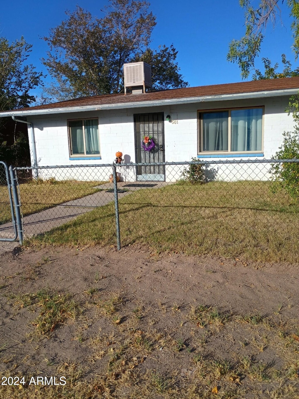 single story home with a front lawn and central AC