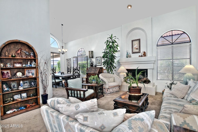 8120 E Cortez Dr, Scottsdale, AZ 85260 - living area with carpet, a chandelier, a fireplace with raised hearth, and a towering ceiling