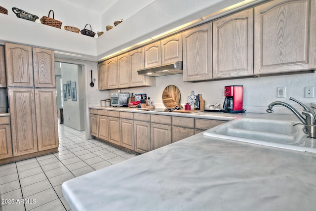 8120 E Cortez Dr, Scottsdale, AZ 85260 - kitchen with under cabinet range hood, light countertops, light tile patterned flooring, black electric cooktop, and light brown cabinetry