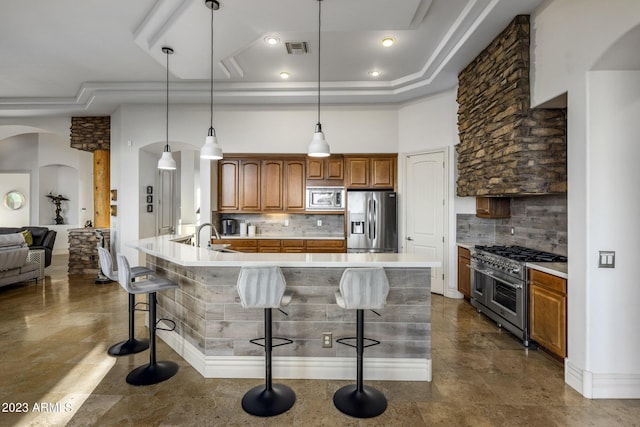 kitchen with a kitchen bar, decorative backsplash, pendant lighting, and stainless steel appliances