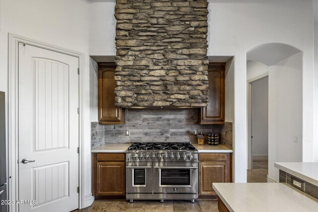 kitchen featuring double oven range and tasteful backsplash