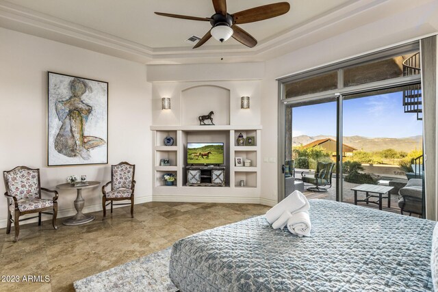 bedroom with a tray ceiling, access to exterior, and ceiling fan