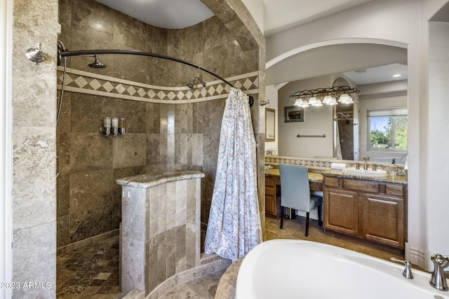 bathroom with vanity and separate shower and tub