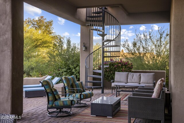 wooden terrace with an outdoor living space and a patio