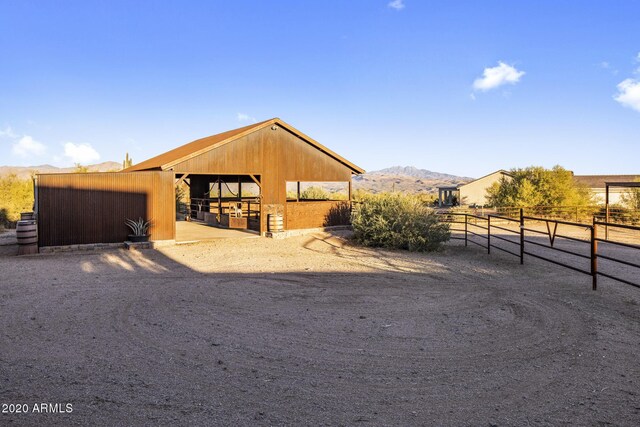 view of front facade featuring a mountain view and an outbuilding