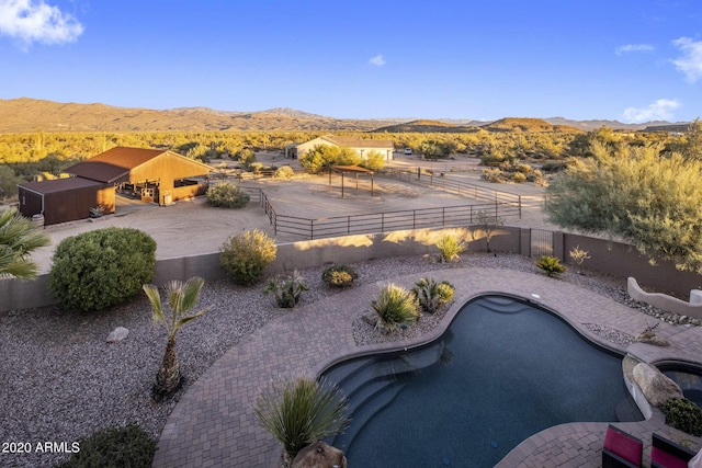 exterior space featuring a fenced in pool and a mountain view