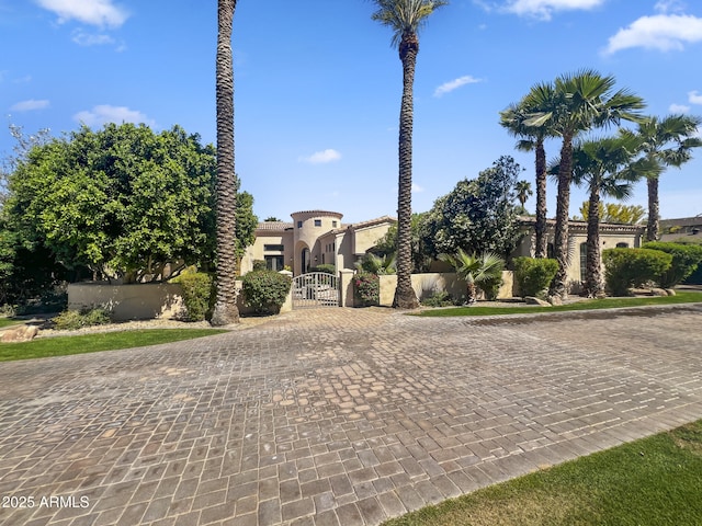 view of front of property featuring a gate and stucco siding