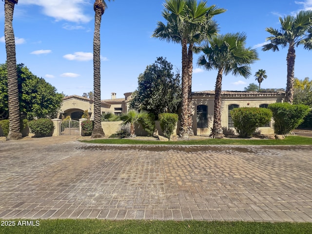 view of front of house with a gate and stucco siding