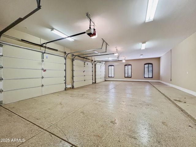 garage with baseboards and a garage door opener