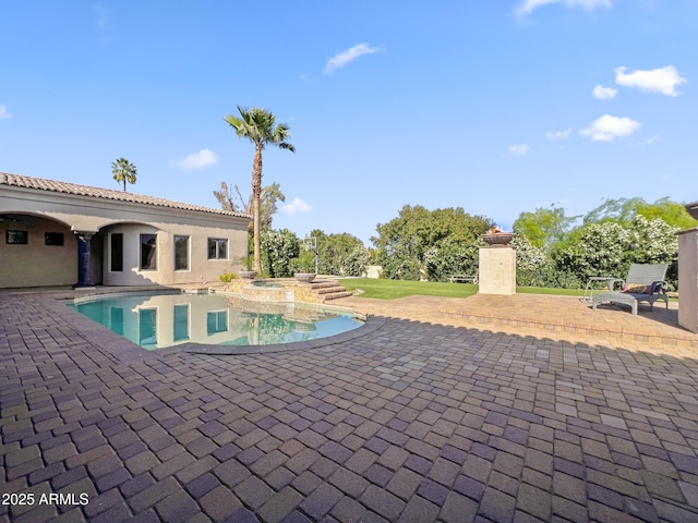 view of swimming pool with a patio area and a pool with connected hot tub