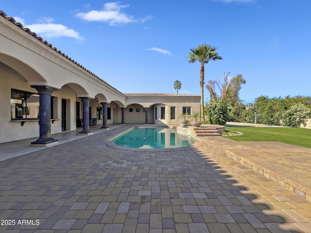 view of swimming pool with a pool with connected hot tub and a patio area