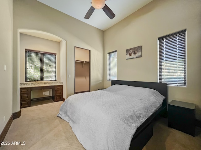 bedroom featuring baseboards, ceiling fan, and light carpet