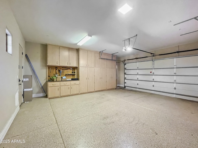 garage with baseboards and a garage door opener
