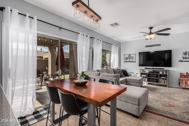 tiled dining room featuring ceiling fan