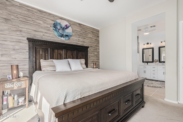 carpeted bedroom featuring ensuite bath