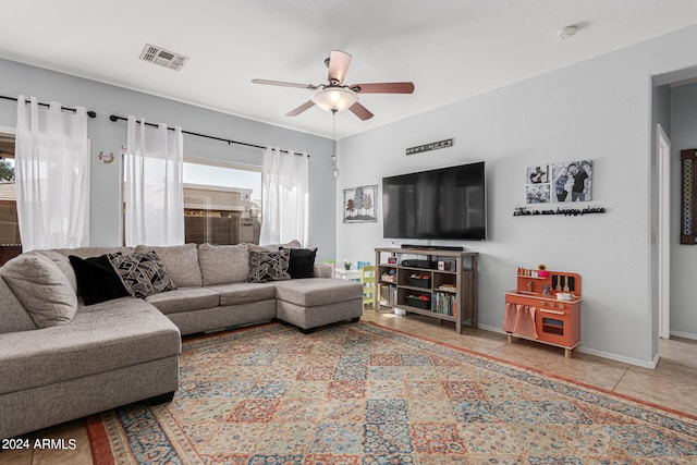 living room featuring tile patterned floors and ceiling fan