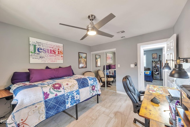 bedroom with ceiling fan and a closet